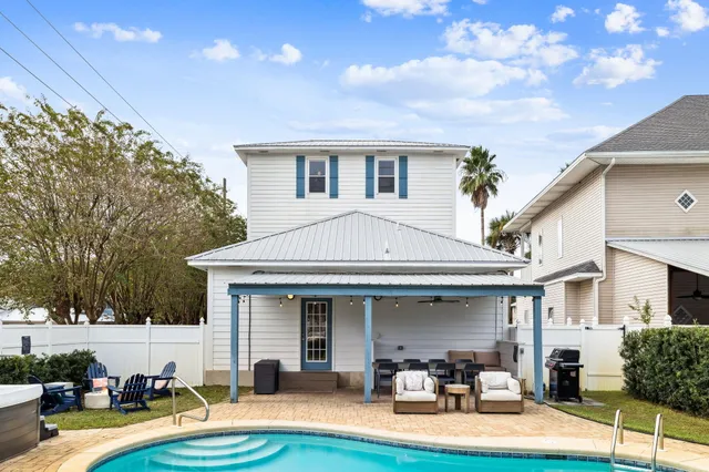 a front view of a house with patio and dining tables