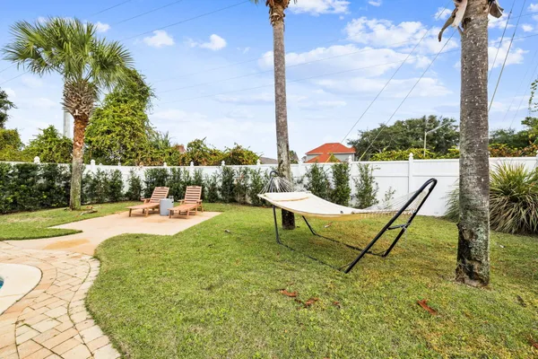 a view of a swimming pool with lawn chairs and a fire pit