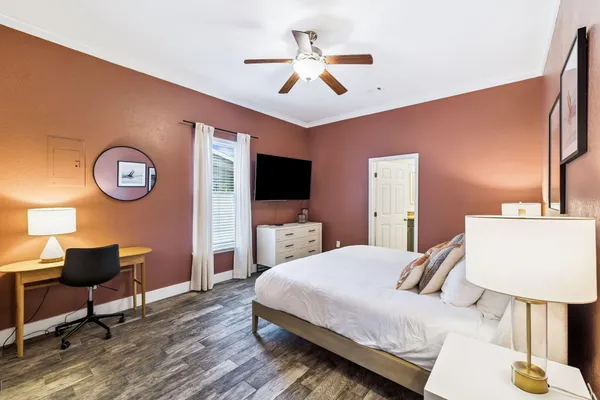 a bedroom with a bed and a chandelier