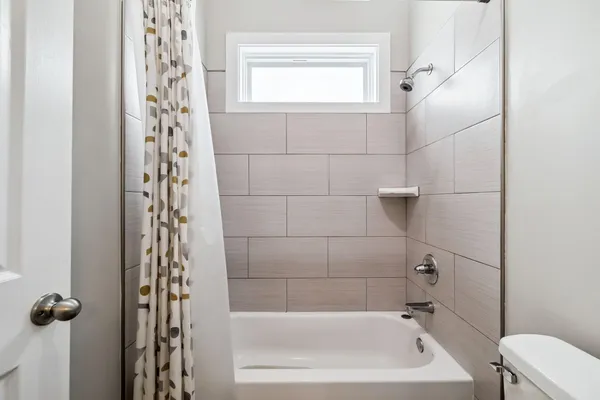 a bathroom with a bathtub and shower