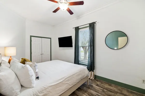 a bedroom with a bed and a chandelier