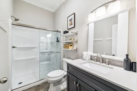 a bathroom with a sink toilet and shower