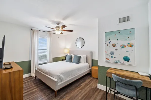 a bedroom with a bed and a chandelier