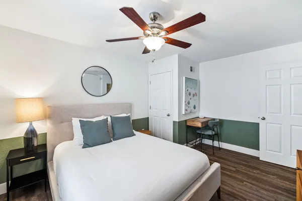 a bedroom with bed and a chandelier