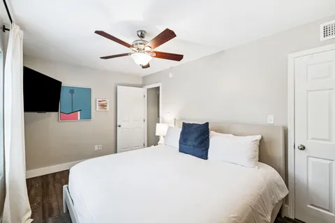 a bedroom with a large bed and a chandelier