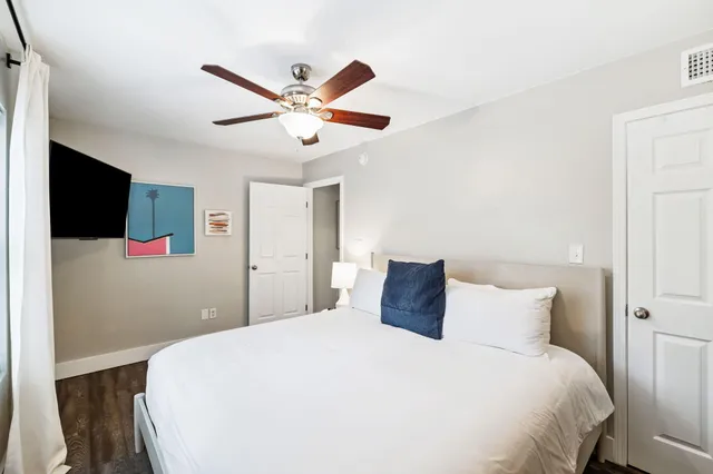 a bedroom with a large bed and a chandelier