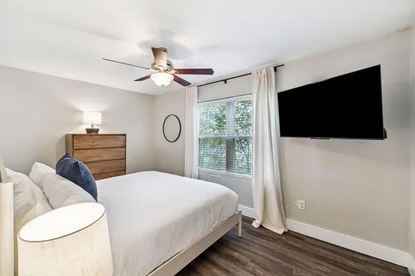 a bedroom with a bed and a flat screen tv