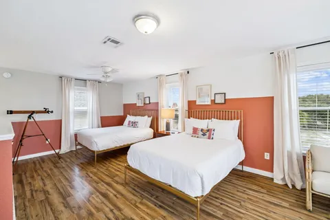 a bedroom with two beds and painted walls