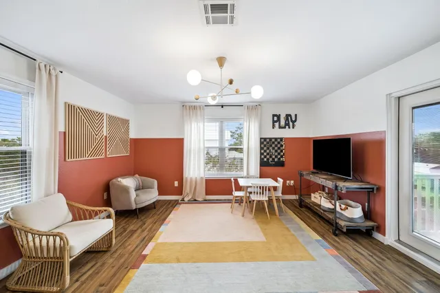 a living room with furniture and a flat screen tv