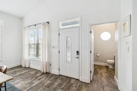 a bathroom with a granite countertop sink a toilet and a shower