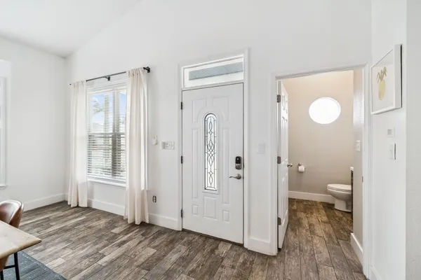 a bathroom with a granite countertop sink a toilet and a shower