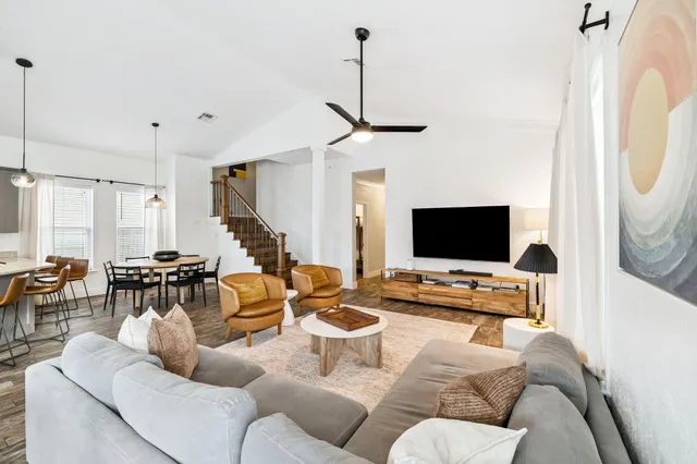 a living room with furniture and a flat screen tv