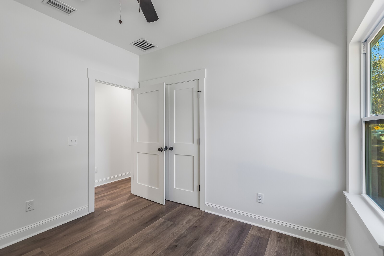 45055 Luther Street Callahan, FL 32011 - Photo 11 of 17 an empty room with wooden floor and windows