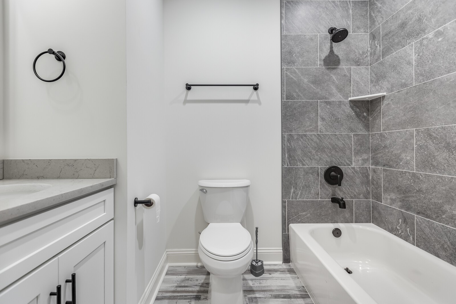 45055 Luther Street Callahan, FL 32011 - Photo 14 of 17 a bathroom with a granite countertop toilet a sink and a bathtub