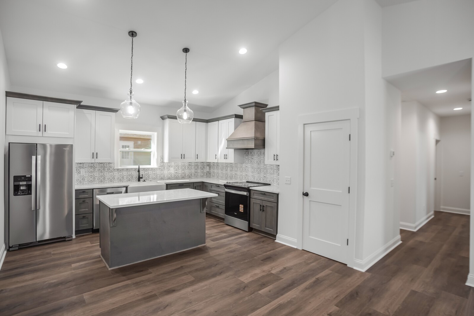 45055 Luther Street Callahan, FL 32011 - Photo 5 of 17 a large kitchen with stainless steel appliances kitchen island a large counter top and a sink