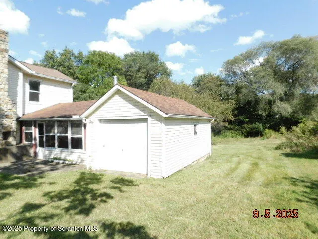 a view of a white house with a yard