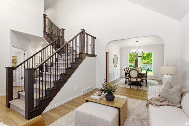 1712 Somerset Ridge Drive Draper, UT 84020 - Photo 11 of 76 Grand staircase featuring dark wood newel posts and handrails with decorative wrought iron balusters