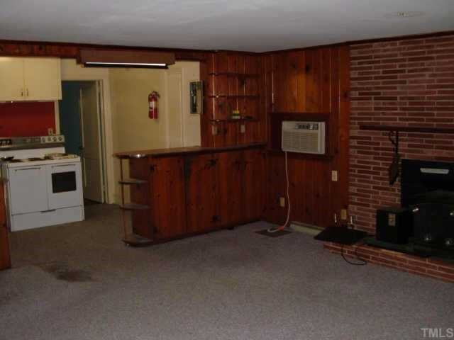 3420 Churchill Road Raleigh, NC 27607 - Photo 5 of 10 family room view of kitchen and fireplace. home needs work but the room dimensions provide ample space in which to create your dream home. Other