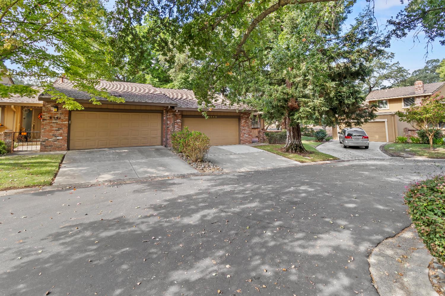 a front view of a house with a yard and a garage