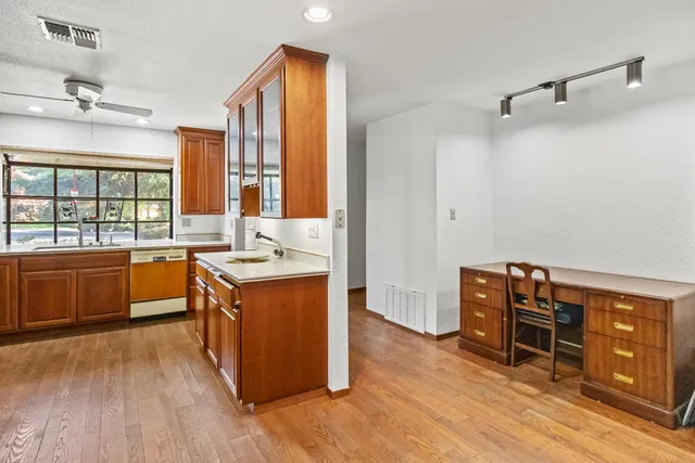 a large kitchen with stainless steel appliances granite countertop a stove and cabinets