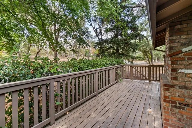 a balcony with wooden floor and fence