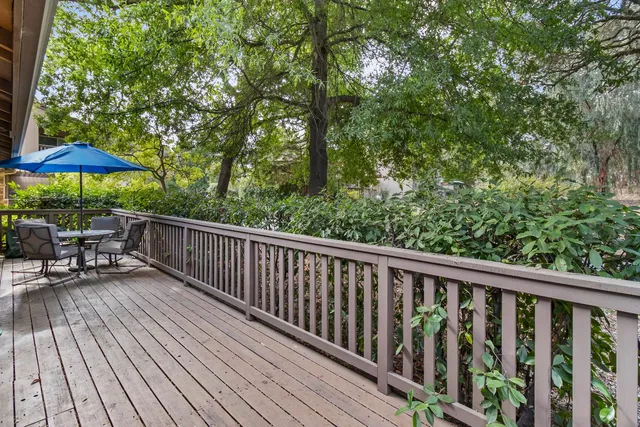 a view of balcony with wooden floor and outdoor seating