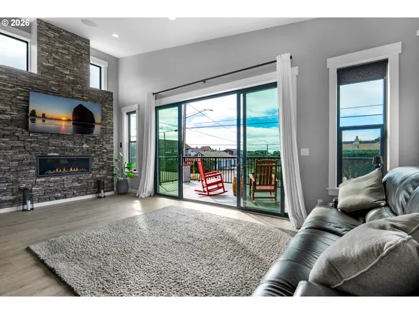 a kitchen with stainless steel appliances kitchen island granite countertop a table chairs and a refrigerator