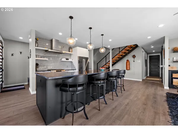 a kitchen with stainless steel appliances kitchen island a large counter space a sink and cabinets