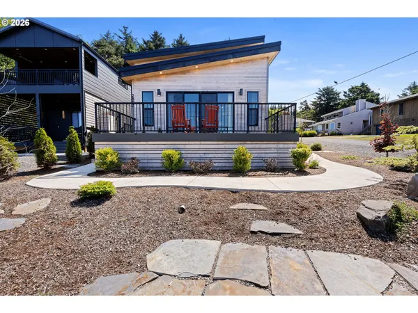 a view of house with yard outdoor seating