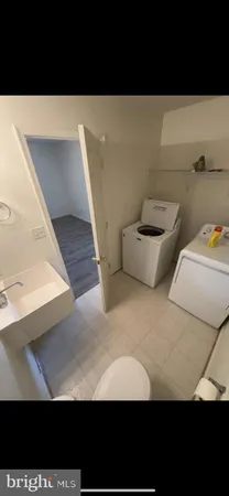 a view of kitchen with kitchen island stainless steel appliances