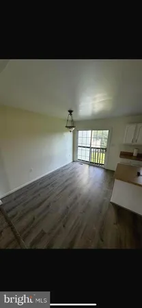 a view of a living room and kitchen area