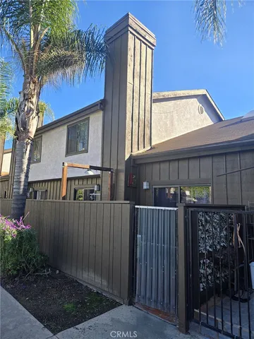 a view of a house with wooden fence