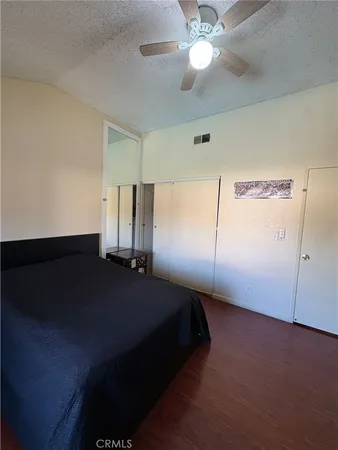 a bed room with a bed and a ceiling fan