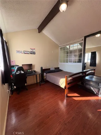 a living room with furniture pool table and a flat screen tv