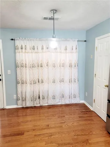 a view of wooden floor and cabinet in a room