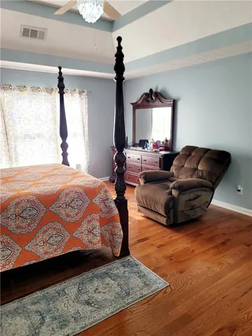 a bedroom with a bed window and couch
