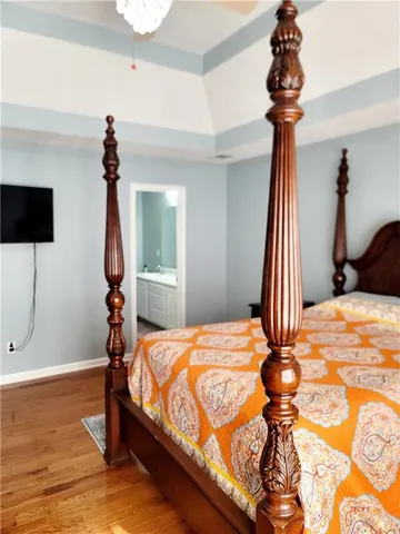 a bedroom with a bed and a chandelier