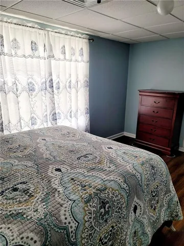 a bedroom with a bed and a dresser