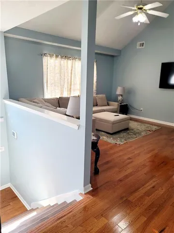 a living room with a bed furniture and a window