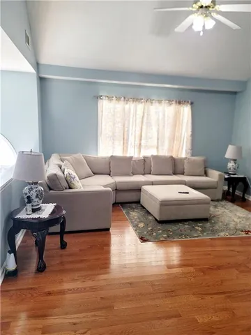 a living room with furniture and wooden floor