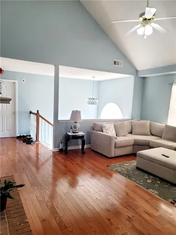 a living room with furniture and a wooden floor