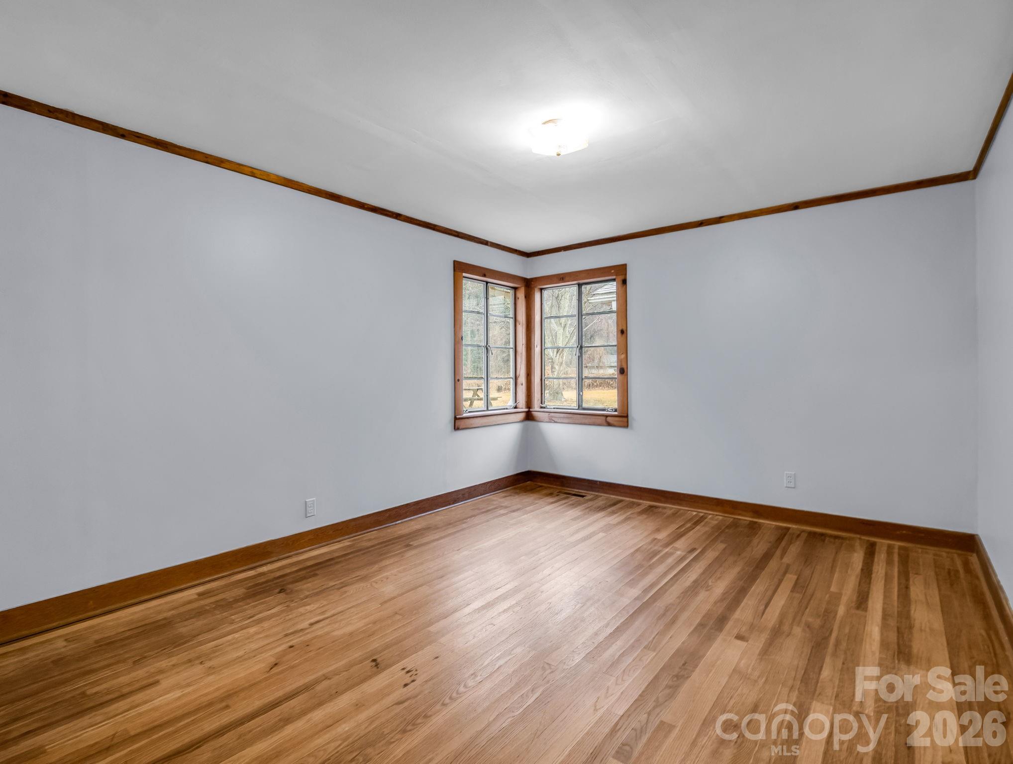 109 Wall Road Tryon, NC 28782 - Photo 20 of 30 an empty room with wooden floor and windows