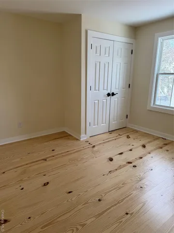 a view of wooden floor and windows in a room