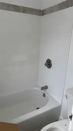 a room with washing machine with wooden floor