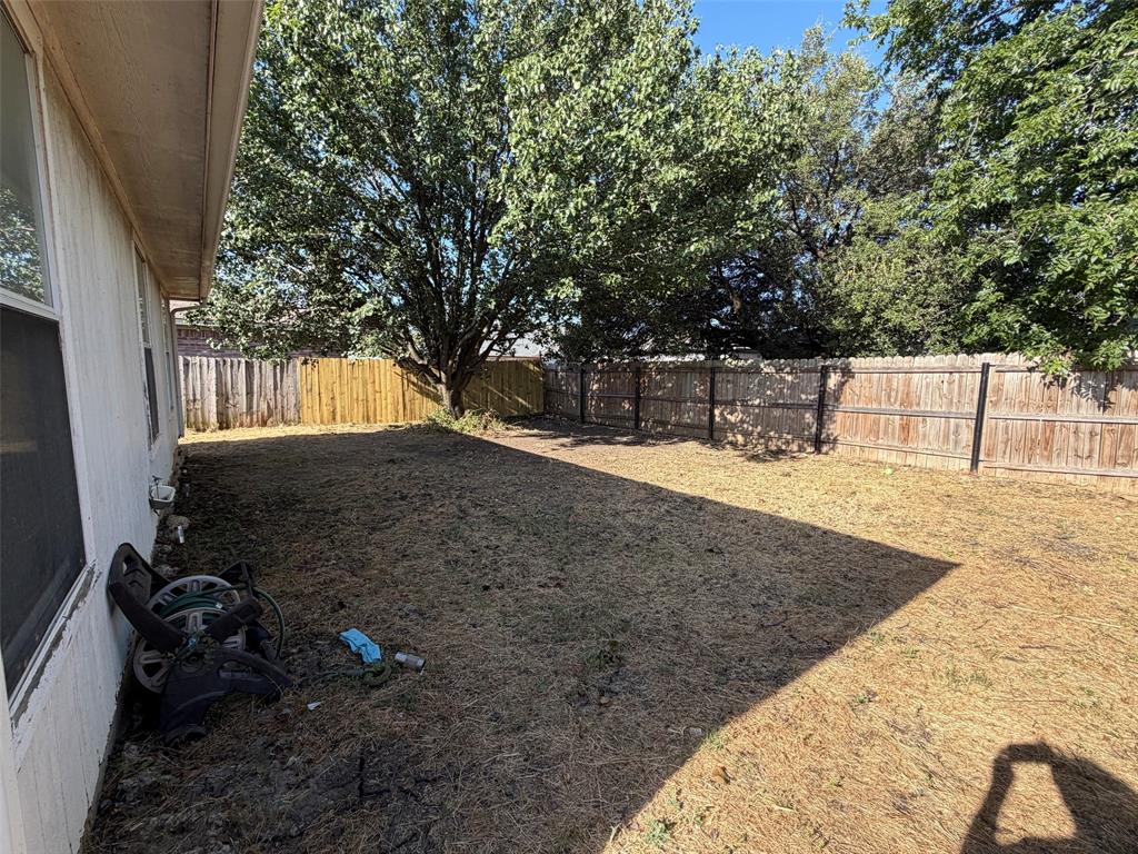 7116 Nohl Ranch Road Fort Worth, TX 76133 - Photo 10 of 10 Back yard with large shade tree