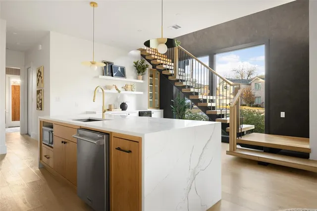a kitchen with sink and refrigerator