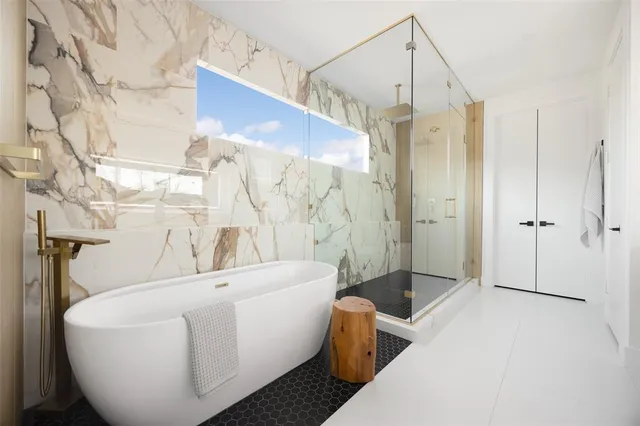 a spacious bathroom with a double vanity sink a mirror and a shower
