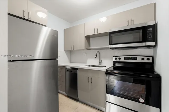a kitchen with stainless steel appliances a stove microwave and a refrigerator