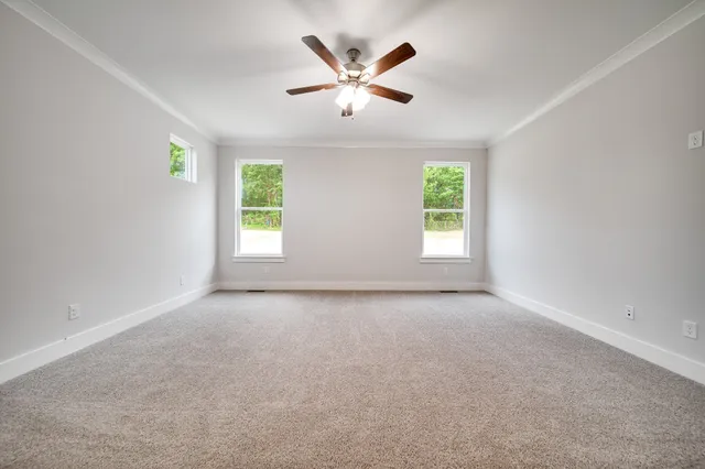 an empty room with windows and closet