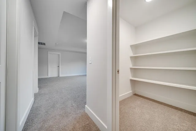 an empty room with a fireplace and fan